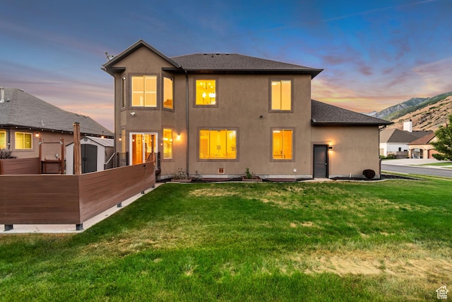4067 W View Pointe Dr N, Highland, UT 84003 - back of property with stucco siding, a shingled roof, a storage unit, and a mountain view