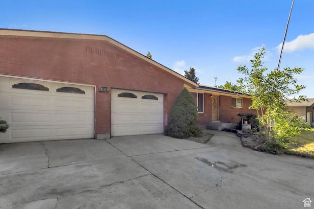 185 S 200 W, Providence, UT 84332 - single story home with a garage, driveway, and brick siding