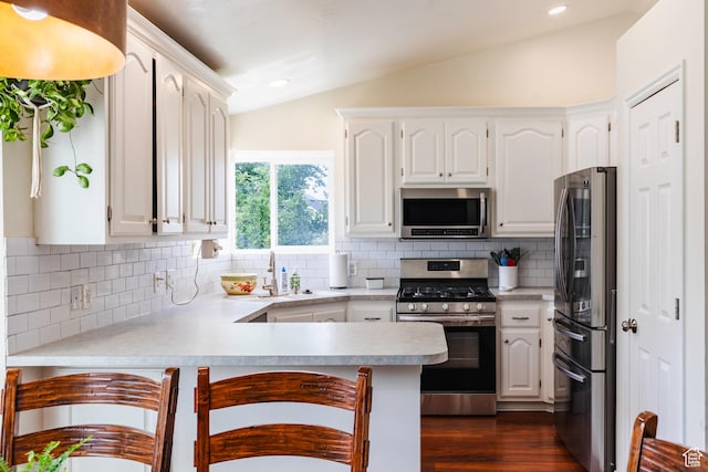 14048 S Van Cott Peak Cir W, Riverton, UT 84096 - kitchen with stainless steel appliances, lofted ceiling, a peninsula, white cabinetry, and light countertops