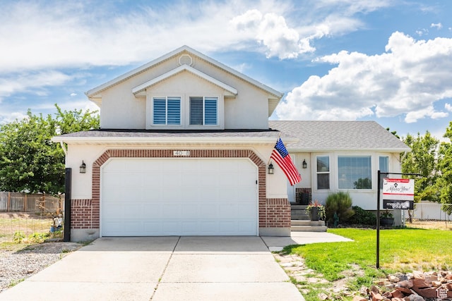 14048 S Van Cott Peak Cir W, Riverton, UT 84096 - view of front of property featuring driveway, brick siding, an attached garage, stucco siding, and a shingled roof