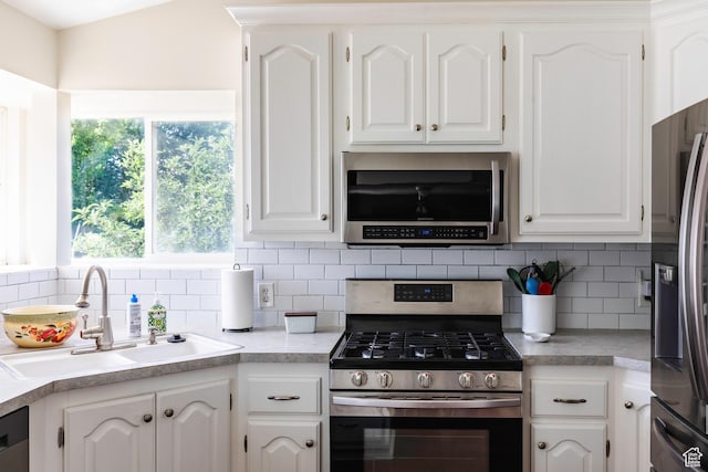 14048 S Van Cott Peak Cir W, Riverton, UT 84096 - kitchen featuring appliances with stainless steel finishes, white cabinetry, and light countertops