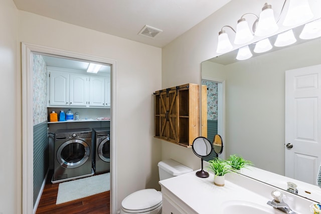 14048 S Van Cott Peak Cir W, Riverton, UT 84096 - bathroom featuring washer and dryer, wood finished floors, and vanity