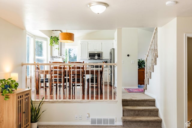 14048 S Van Cott Peak Cir W, Riverton, UT 84096 - carpeted dining area with stairs and baseboards