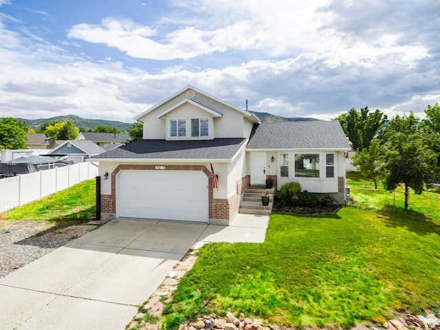 14048 S Van Cott Peak Cir W, Riverton, UT 84096 - view of front facade with brick siding, a shingled roof, concrete driveway, and an attached garage