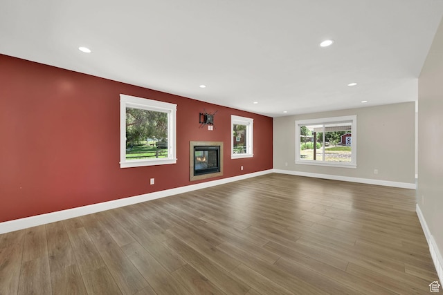 6699 E 950 S, Huntsville, UT 84317 - unfurnished living room featuring wood finished floors, a glass covered fireplace, and recessed lighting