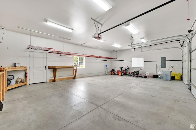 6699 E 950 S, Huntsville, UT 84317 - garage with electric panel, a garage door opener, and a workshop area