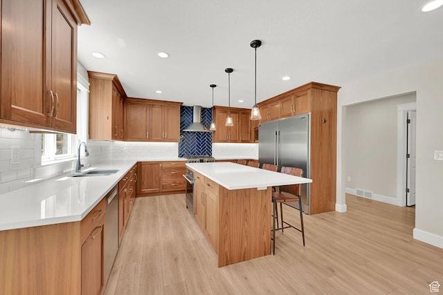 6699 E 950 S, Huntsville, UT 84317 - kitchen with high end appliances, a kitchen island, wall chimney exhaust hood, a kitchen bar, and tasteful backsplash