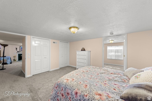 180 N 1100 E Unit 190, Washington, UT 84780 - bedroom featuring multiple closets, carpet, and a textured ceiling