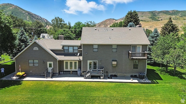 36 N Main St, Mantua, UT 84324 - rear view of house featuring a patio area, french doors, a mountain view, and a lawn