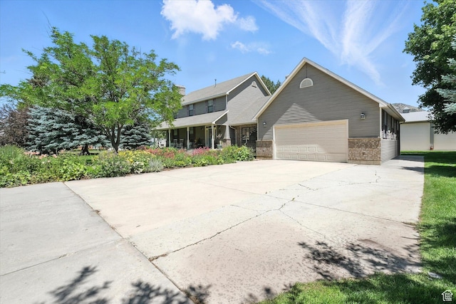 36 N Main St, Mantua, UT 84324 - view of front of home with brick siding, an attached garage, and concrete driveway