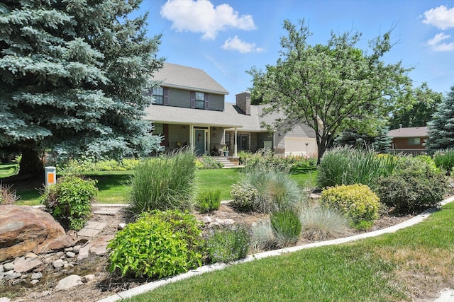 36 N Main St, Mantua, UT 84324 - view of front of house with a chimney, a front yard, and a porch