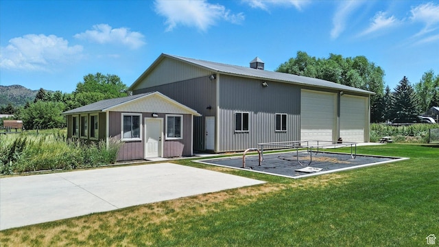 36 N Main St, Mantua, UT 84324 - back of property with an outbuilding, a yard, a detached garage, and a metal roof
