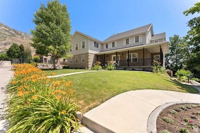 1060 E 1100 N, Pleasant Grove, UT 84062 - view of front facade with covered porch, brick siding, a front lawn, and a mountain view