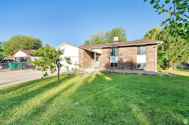 45 W 900 S, Layton, UT 84041 - view of front of property with driveway, a front lawn, brick siding, and an attached garage