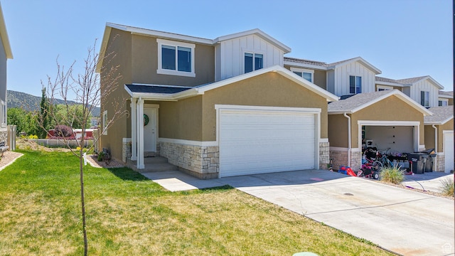 628 E 625 S, Nephi, UT 84648 - view of property with stone siding, board and batten siding, a front yard, concrete driveway, and stucco siding