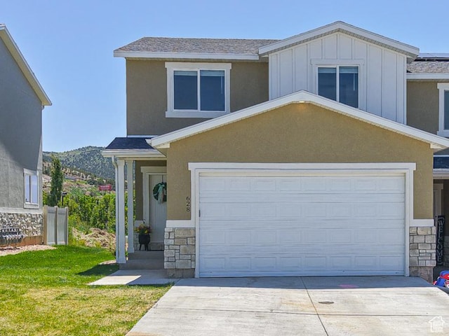 628 E 625 S, Nephi, UT 84648 - view of front of property featuring stone siding, concrete driveway, board and batten siding, and an attached garage