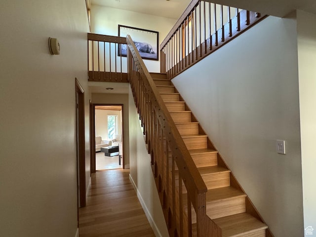 8463 S Jackson Hole Dr E, Sandy, UT 84093 - stairway with a high ceiling and wood finished floors