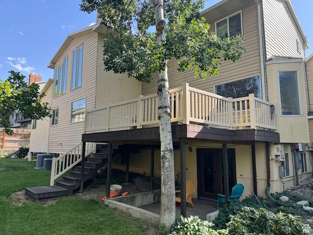 8463 S Jackson Hole Dr E, Sandy, UT 84093 - back of property featuring a lawn, a wooden deck, stairs, and a patio