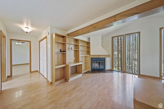 8463 S Jackson Hole Dr E, Sandy, UT 84093 - unfurnished living room featuring a fireplace with flush hearth, light wood-style floors, and a ceiling fan