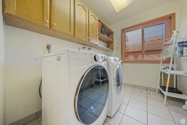 8463 S Jackson Hole Dr E, Sandy, UT 84093 - washroom featuring cabinet space, independent washer and dryer, and light tile patterned floors