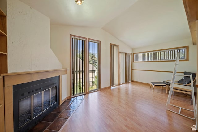 8463 S Jackson Hole Dr E, Sandy, UT 84093 - living area with a fireplace with flush hearth, lofted ceiling, and wood finished floors