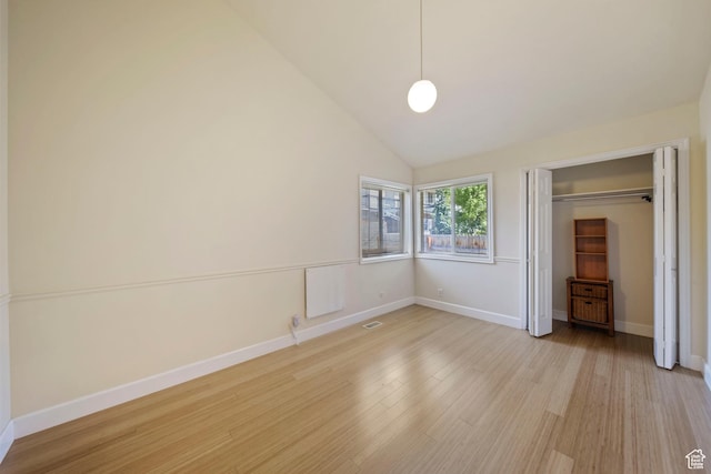 8463 S Jackson Hole Dr E, Sandy, UT 84093 - unfurnished bedroom with light wood-style flooring, a closet, and lofted ceiling