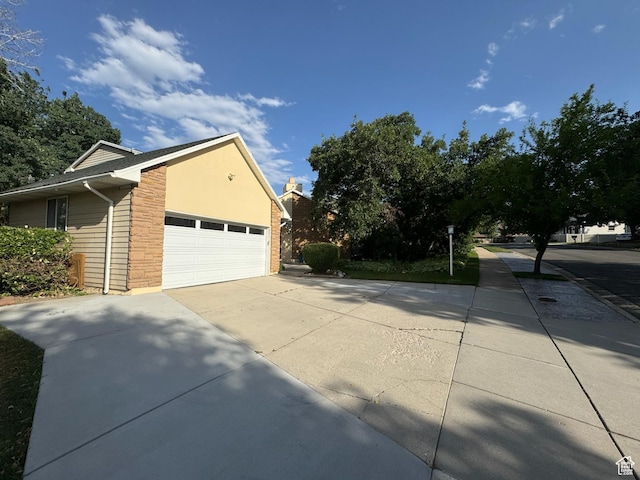 8463 S Jackson Hole Dr E, Sandy, UT 84093 - view of home's exterior with a garage and concrete driveway