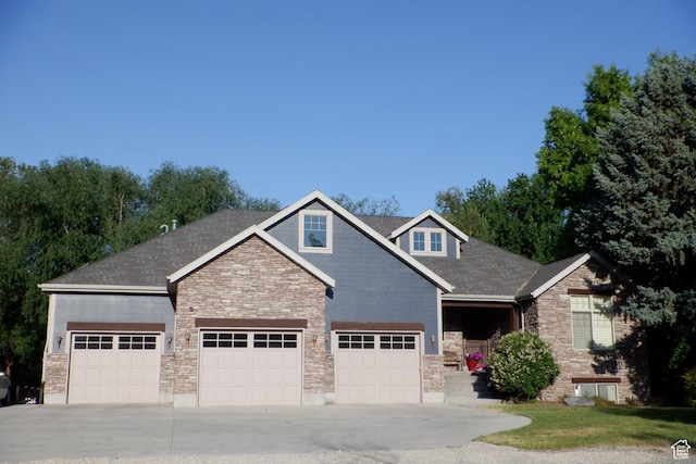 62 S Flint St W, Kaysville, UT 84037 - craftsman house featuring an attached garage, stone siding, concrete driveway, and roof with shingles