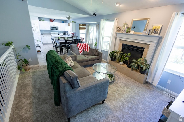 8298 S Festive Way, West Jordan, UT 84088 - living room with vaulted ceiling, light colored carpet, and a fireplace