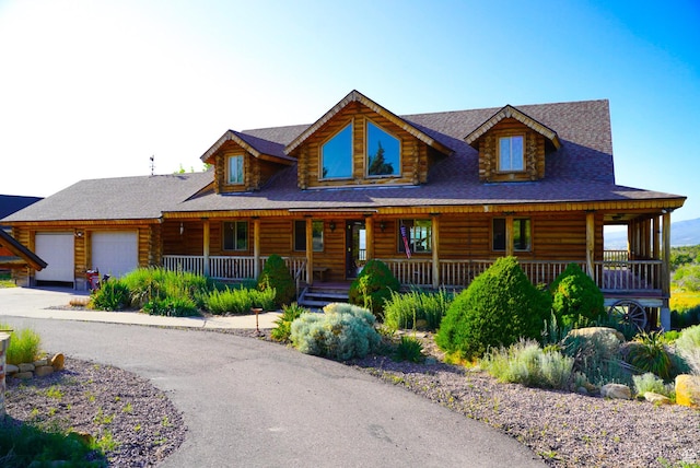 11495 E 16000 N, Mount Pleasant, UT 84647 - cabin with log exterior, covered porch, an attached garage, and driveway