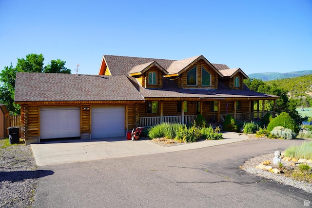 11495 E 16000 N, Mount Pleasant, UT 84647 - log-style house with log siding, a garage, covered porch, and concrete driveway