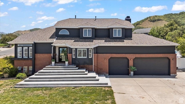 4104 S Bridlewood Dr E, Bountiful, UT 84010 - view of front of property featuring brick siding, concrete driveway, a mountain view, and roof with shingles