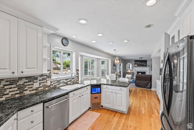 4104 S Bridlewood Dr E, Bountiful, UT 84010 - kitchen with freestanding refrigerator, dishwasher, a peninsula, white cabinets, and recessed lighting