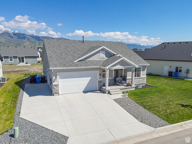 536 N 770 W, Smithfield, UT 84335 - view of front of home with stone siding, a garage, covered porch, and a shingled roof