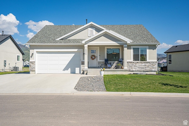 536 N 770 W, Smithfield, UT 84335 - view of front of house with a porch, stone siding, stucco siding, a front yard, and a garage