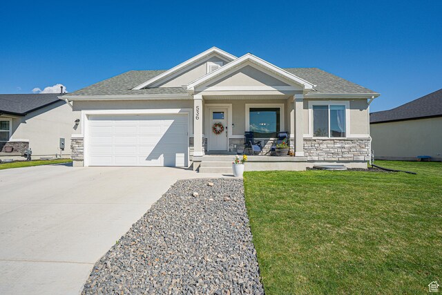 536 N 770 W, Smithfield, UT 84335 - ranch-style house featuring covered porch, stone siding, concrete driveway, stucco siding, and a garage