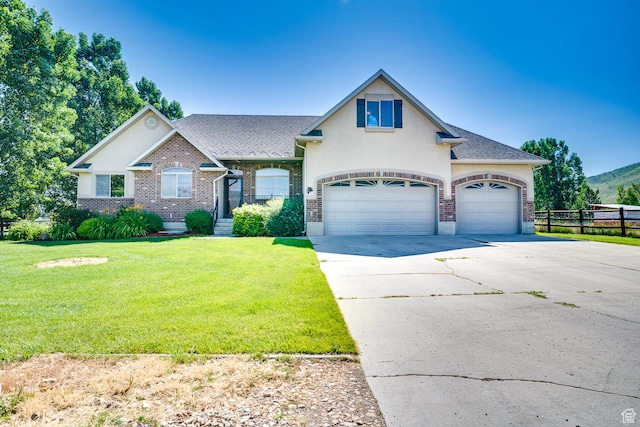 3035 S Big Hollow Rd, Heber City, UT 84032 - view of front of house featuring driveway, stucco siding, a garage, and brick siding