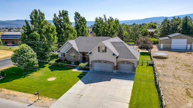 3035 S Big Hollow Rd, Heber City, UT 84032 - view of front of house featuring concrete driveway, roof with shingles, a mountain view, and brick siding