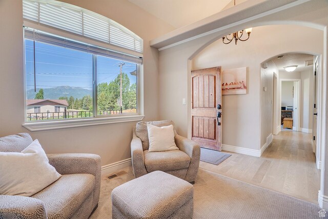 3035 S Big Hollow Rd, Heber City, UT 84032 - sitting room featuring arched walkways, a chandelier, and light wood-type flooring