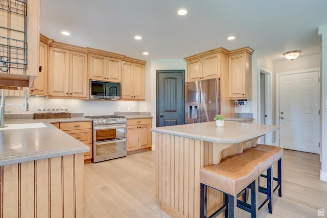 3035 S Big Hollow Rd, Heber City, UT 84032 - kitchen featuring stainless steel appliances, light brown cabinetry, light wood-style flooring, and recessed lighting