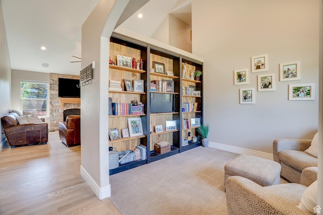 3035 S Big Hollow Rd, Heber City, UT 84032 - sitting room featuring a stone fireplace, recessed lighting, and light wood-style flooring