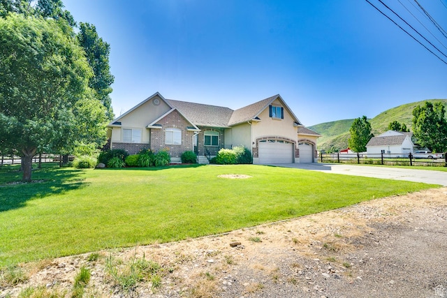 3035 S Big Hollow Rd, Heber City, UT 84032 - view of front facade with driveway, a mountain view, stucco siding, and an attached garage