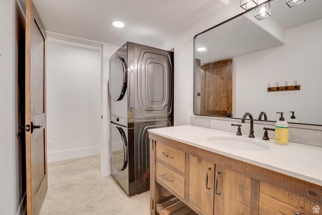 3035 S Big Hollow Rd, Heber City, UT 84032 - bathroom featuring estacked washer and dryer, recessed lighting, vanity, concrete flooring, and a textured ceiling