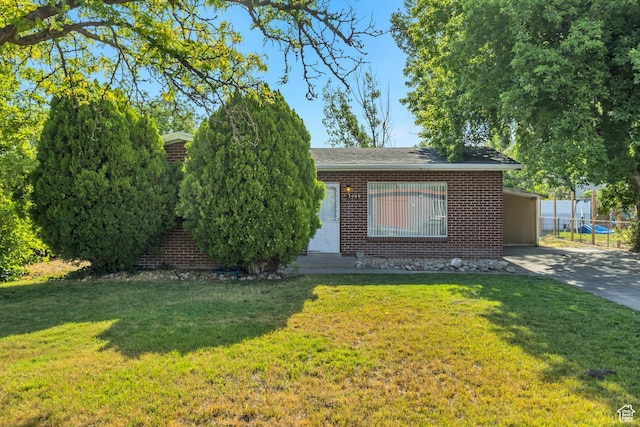 3409 S Maple Way, Salt Lake City, UT 84119 - view of front of house with brick siding, driveway, and a carport