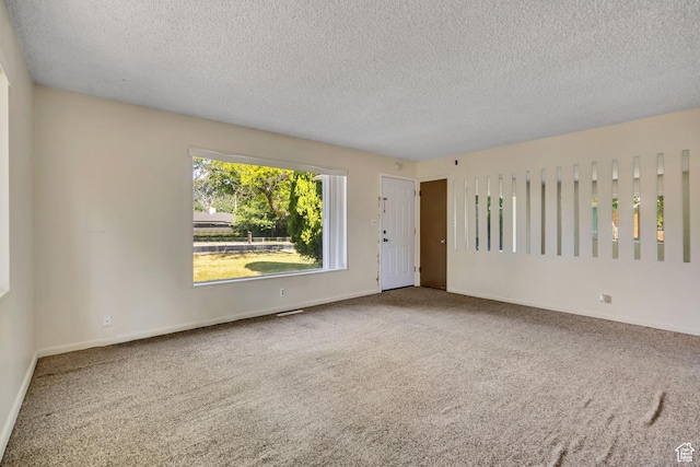 3409 S Maple Way, Salt Lake City, UT 84119 - carpeted spare room featuring a textured ceiling and baseboards