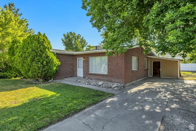 3409 S Maple Way, Salt Lake City, UT 84119 - single story home featuring a front yard, concrete driveway, brick siding, and an attached carport