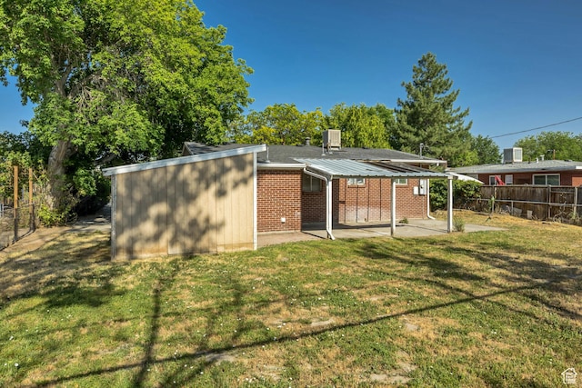 3409 S Maple Way, Salt Lake City, UT 84119 - rear view of property with a patio area, a fenced backyard, and brick siding