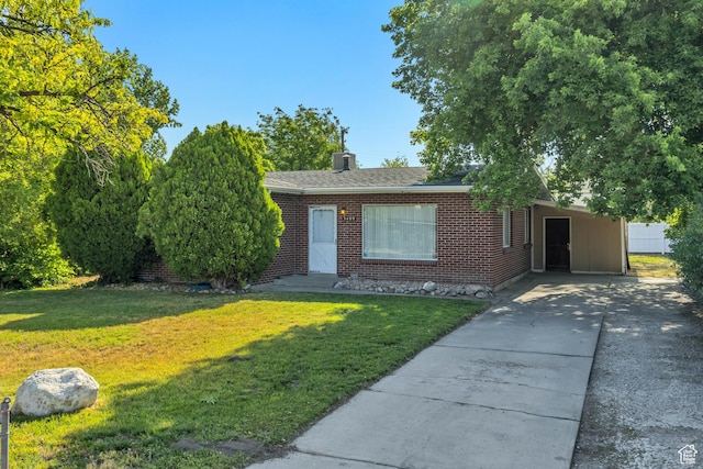 3409 S Maple Way, Salt Lake City, UT 84119 - view of front of house with concrete driveway, a front lawn, brick siding, and a carport