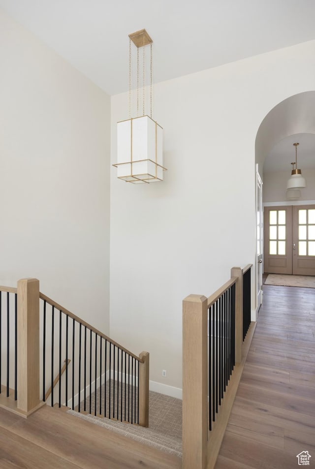 14277 S Keely Ct, Bluffdale, UT 84065 - stairway featuring arched walkways, wood finished floors, and french doors