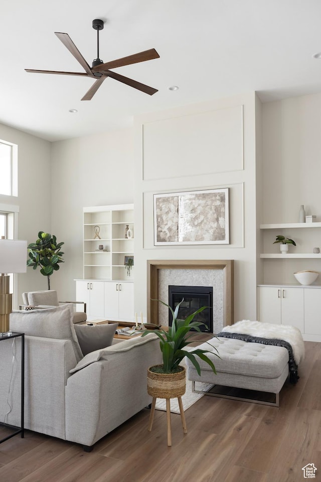 14277 S Keely Ct, Bluffdale, UT 84065 - living room with a ceiling fan, wood finished floors, a glass covered fireplace, recessed lighting, and built in features